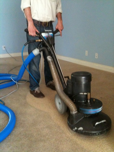 Eco-Dry Carpet Care technician with a rotary machine